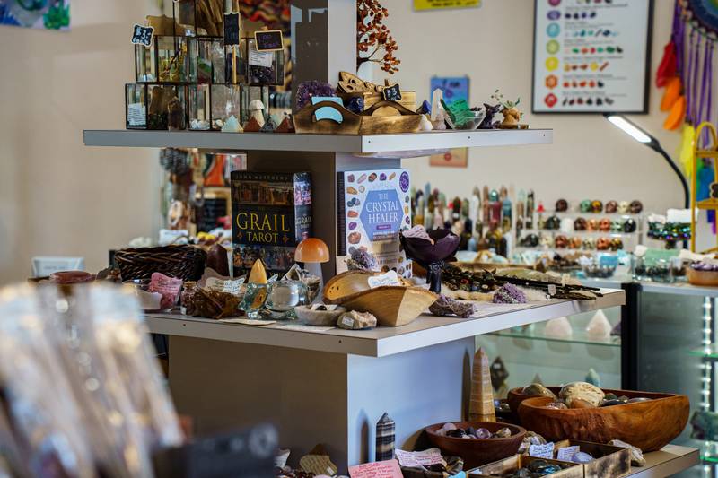Shelves of crystals, books and gifts inside a small crystal shop