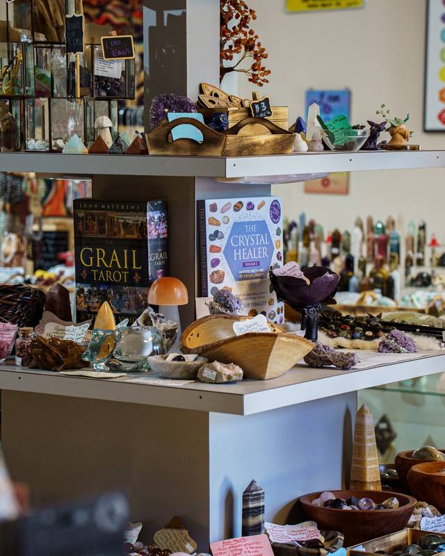 Shelves of crystals, books and gifts inside a small crystal shop